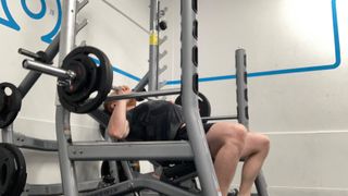 The author performs an incline bench press