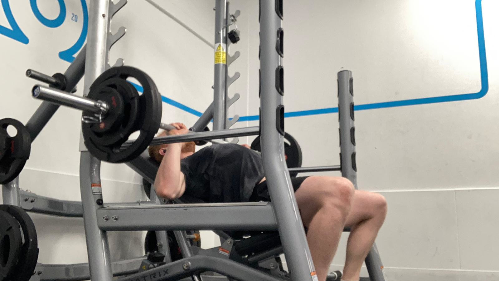 The author performs an incline bench press