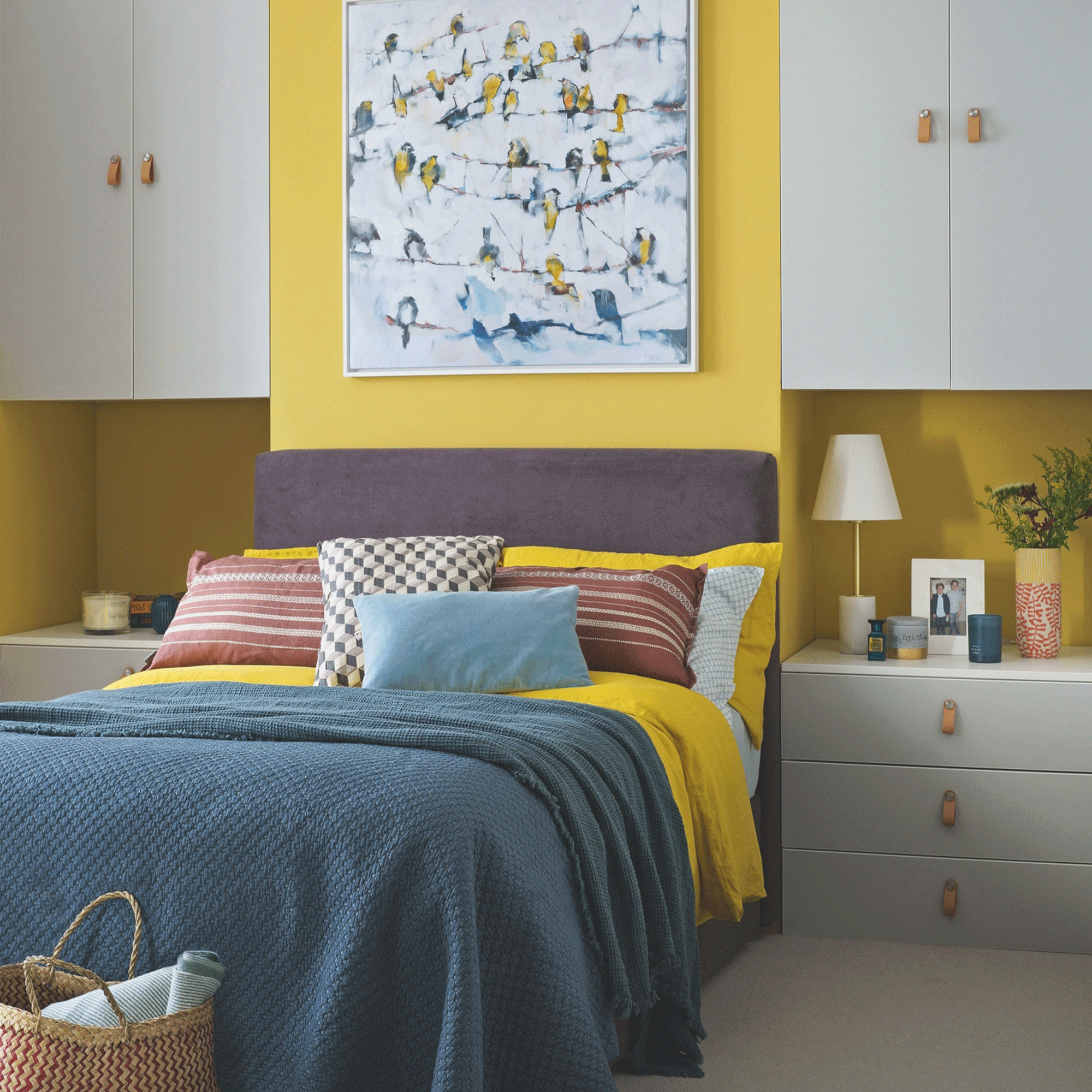 yellow bedroom with blue cupboards