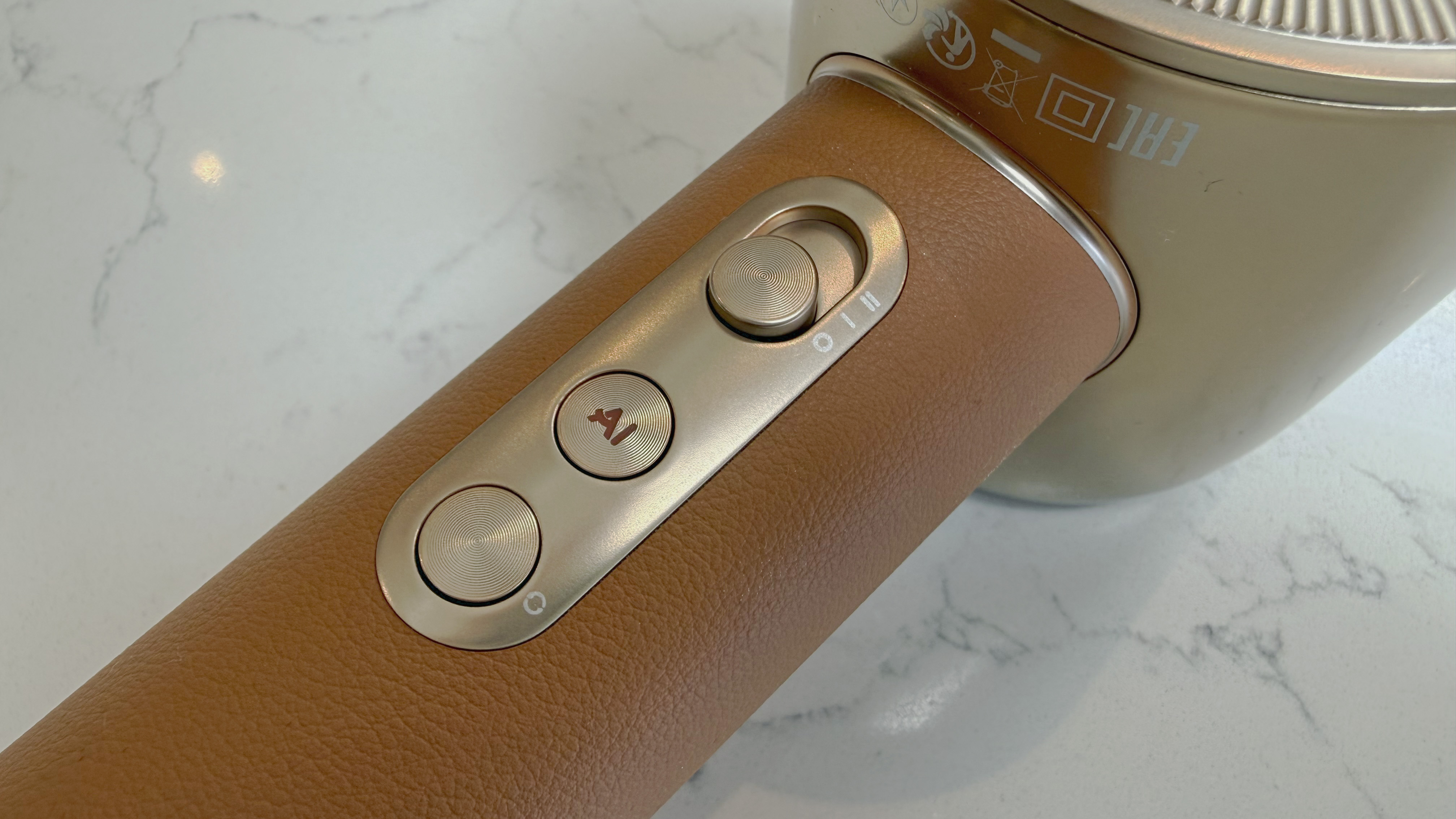 Close-up of Dreame Miracle Pro handle showing control buttons, including power slider and AI mode button