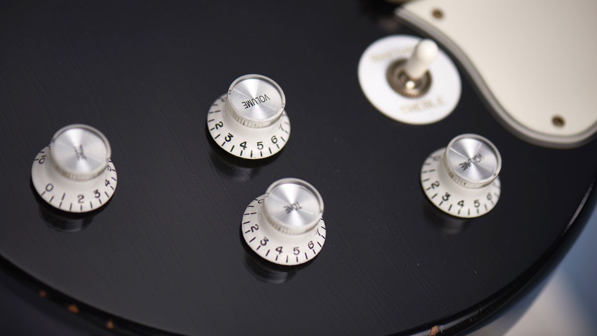 The twin volume and tone knobs, pickguard, pickup selector switch and ring all look great in this unusual white finish