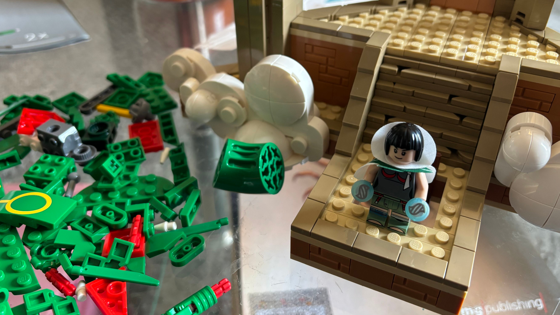 Lego Rayquaza set partially assembled on a glass table