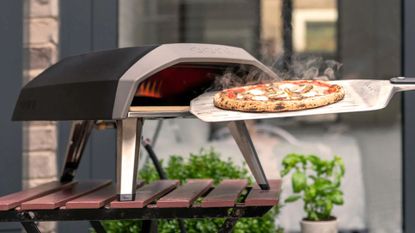 An Ooni Koda 12 pizza oven with a cooked pizza