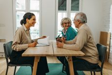 Couple meeting with a financial adviser to plan their retirement, estate planning
