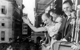 President Juan Peron and his wife Evita wave from a balcony