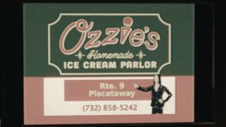 Screenshot of Ozzie's Homemade Ice Cream sign with phone number in Yellowjackets Season 3