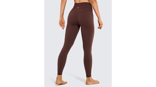 A model from the back wearing a maroon colored pair of high-waisted leggings, for the best leggings on Amazon.