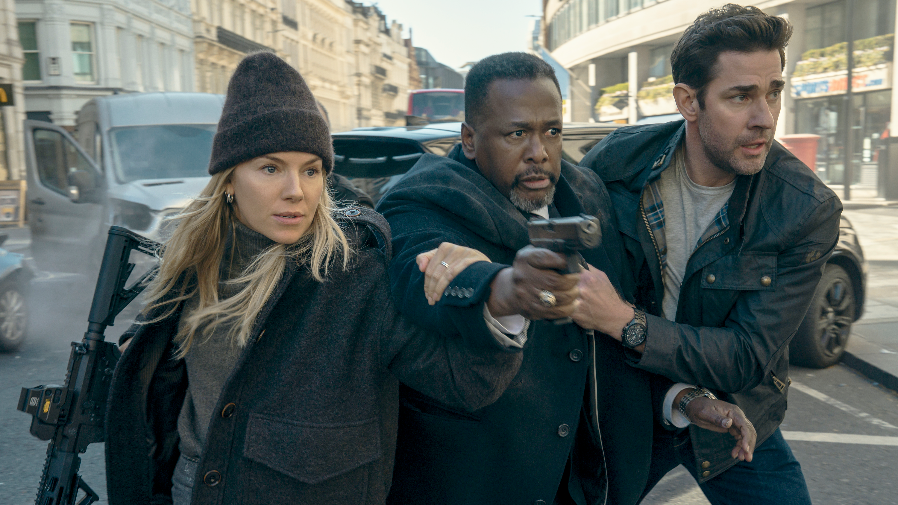 (L-R) Emma Marlowe (Sienna Miller), James Greer (Wendell Pierce) and Jack Ryan (John Krasinski) in "Tom Clancy's Jack Ryan: Ghost War" (2026)