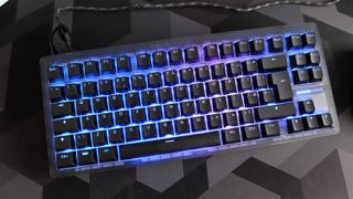 The Wooting 8-HE on a mouse pad with RGB lighting enabled.