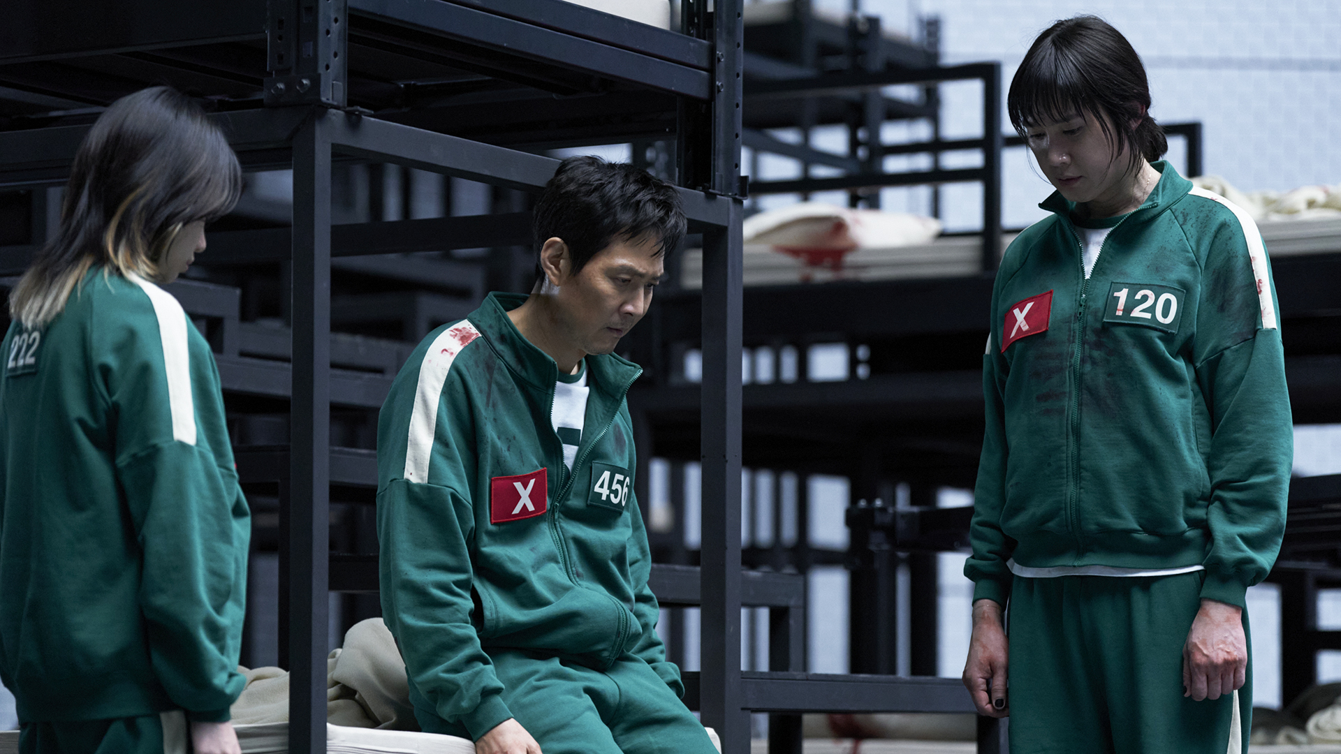 Jun-hee, Gi-hun, and Hyun-ju staring at the ground in despair in Squid Game season 3