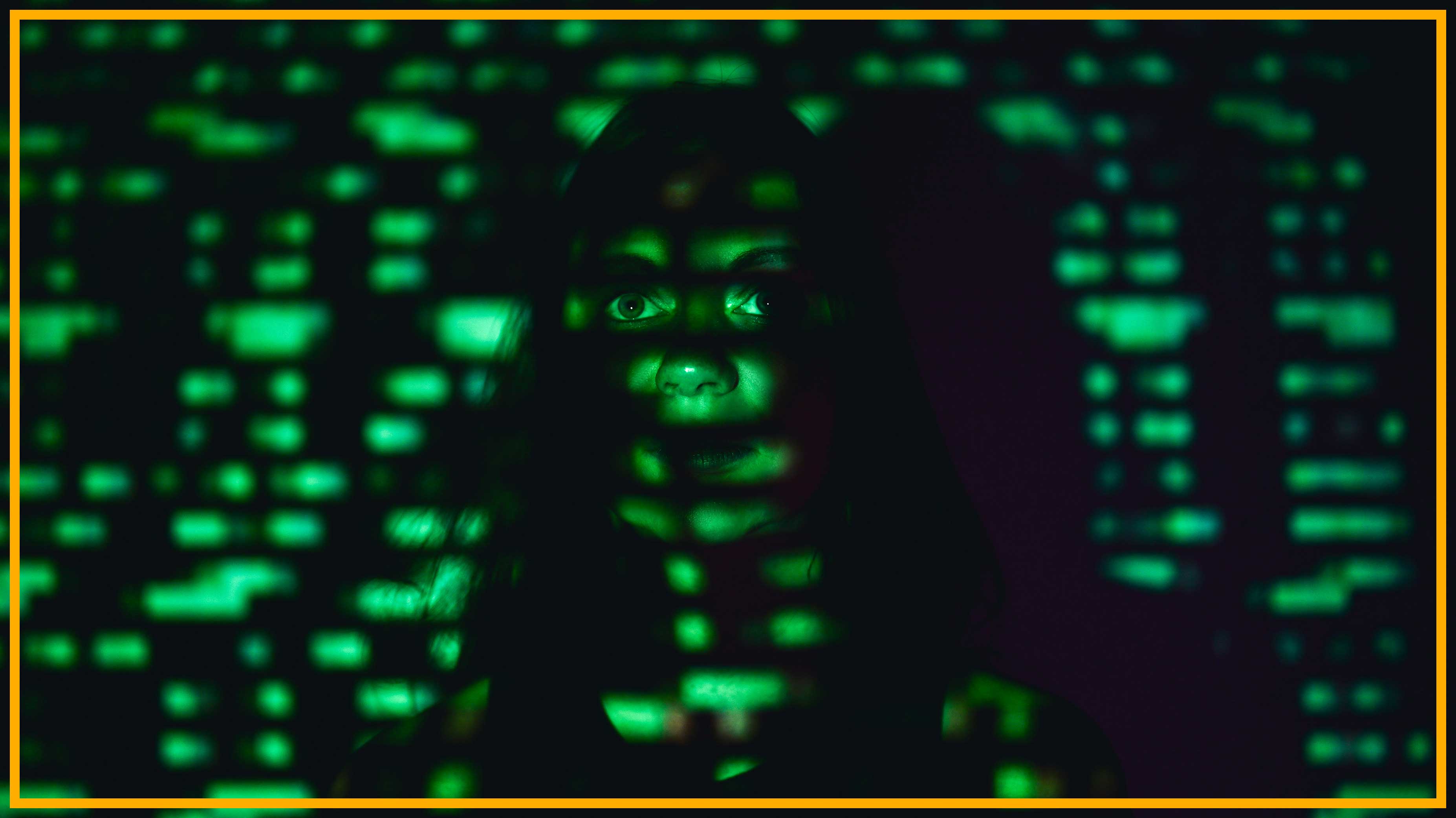 Woman's face glowing with green futuristic data projection