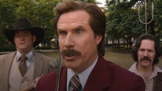Will Ferrell stands amazed in front of David Koechner and Paul Rudd in Anchorman 2 The Legend Continues.