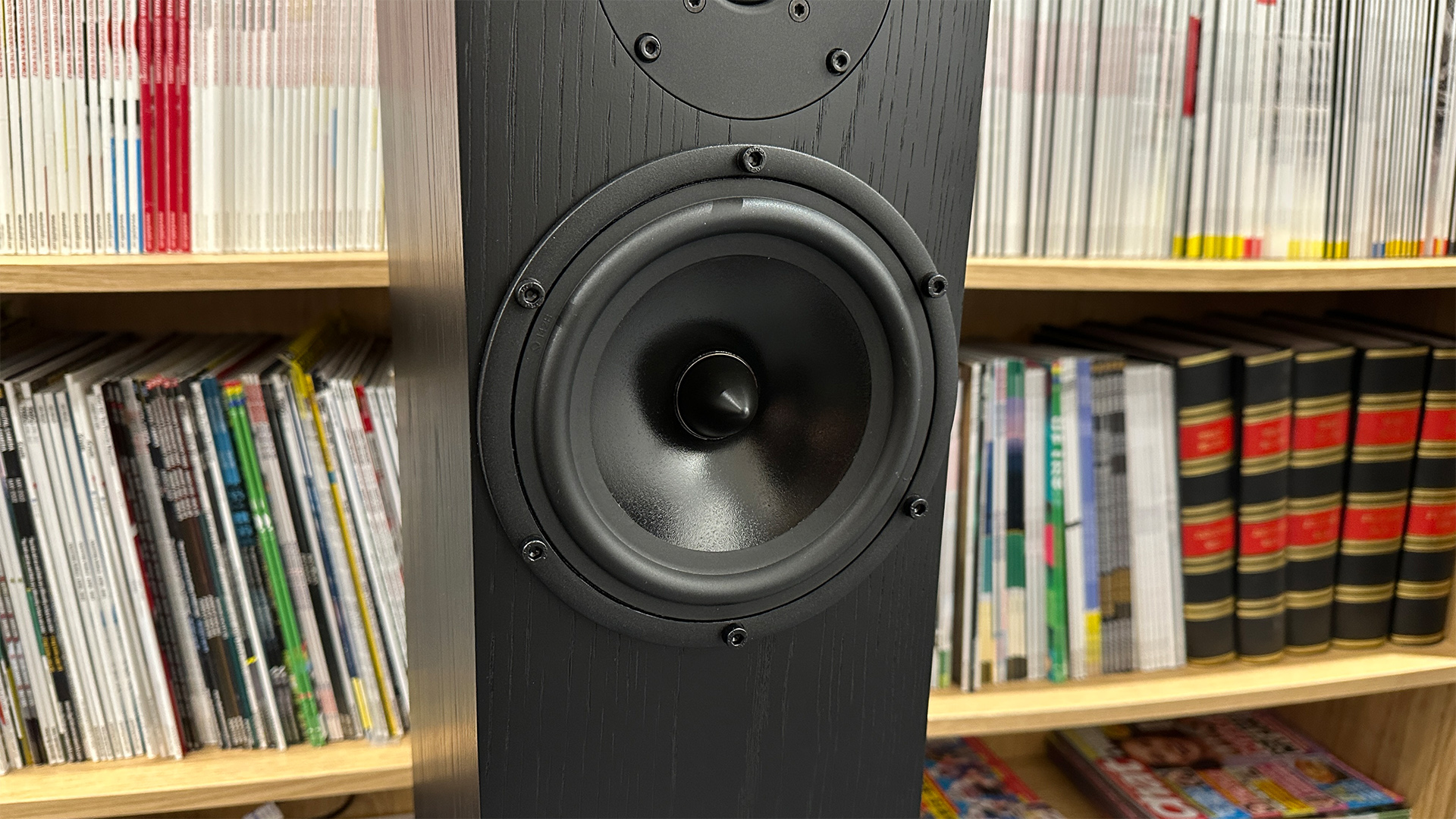 Spendor A7.2 floorstanding speaker in front of bookcase showing mid/bass driver