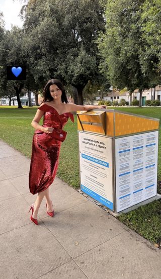 A photo of Selena Gomez posing with a mailbox after voting for Kamala Harris by mail.