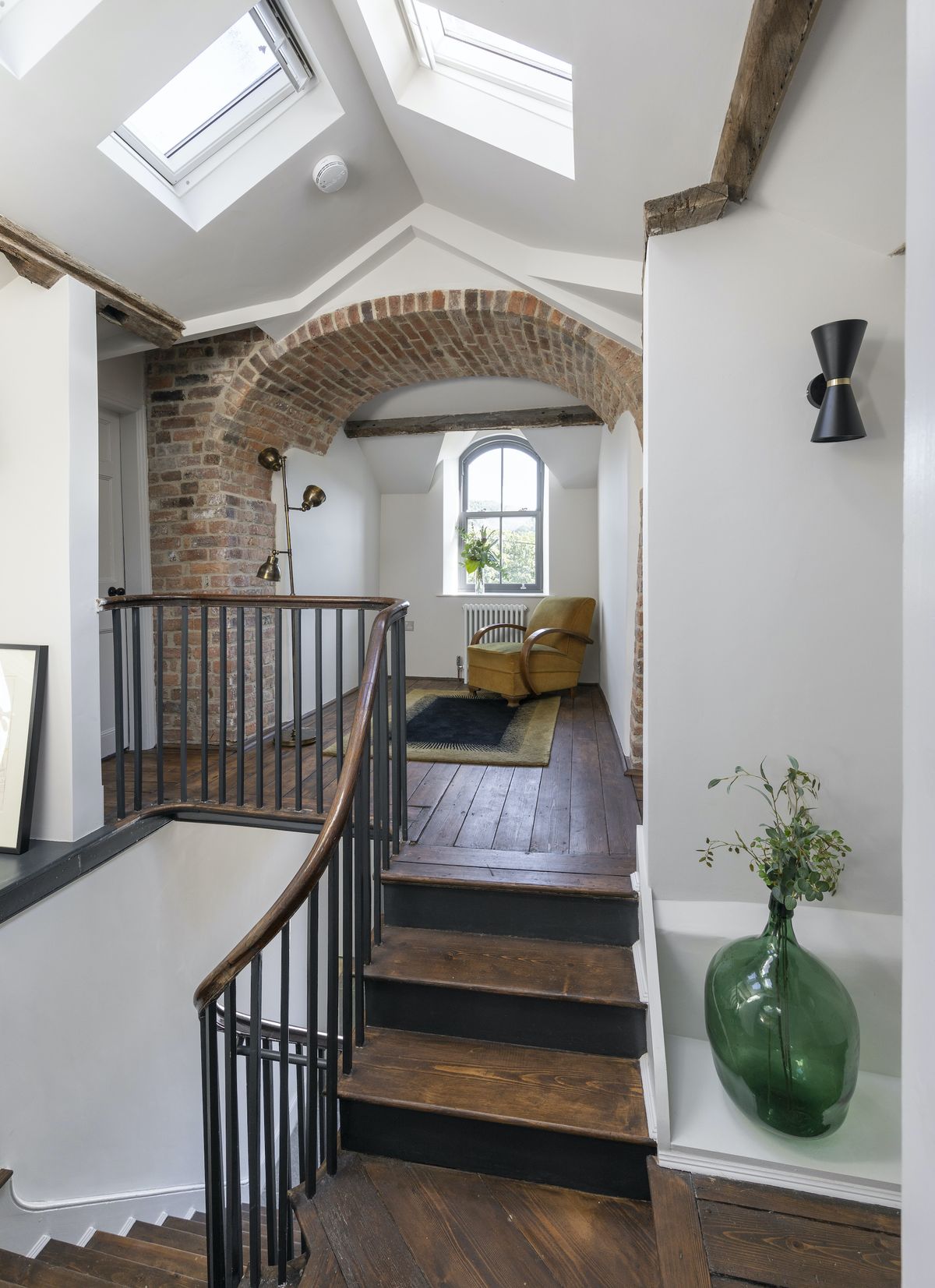 The redbrick archway to the first floor is where the two chimneys either side of the hallway join. Where it had previously been plastered over, it now makes a dramatic landing filled with light.
