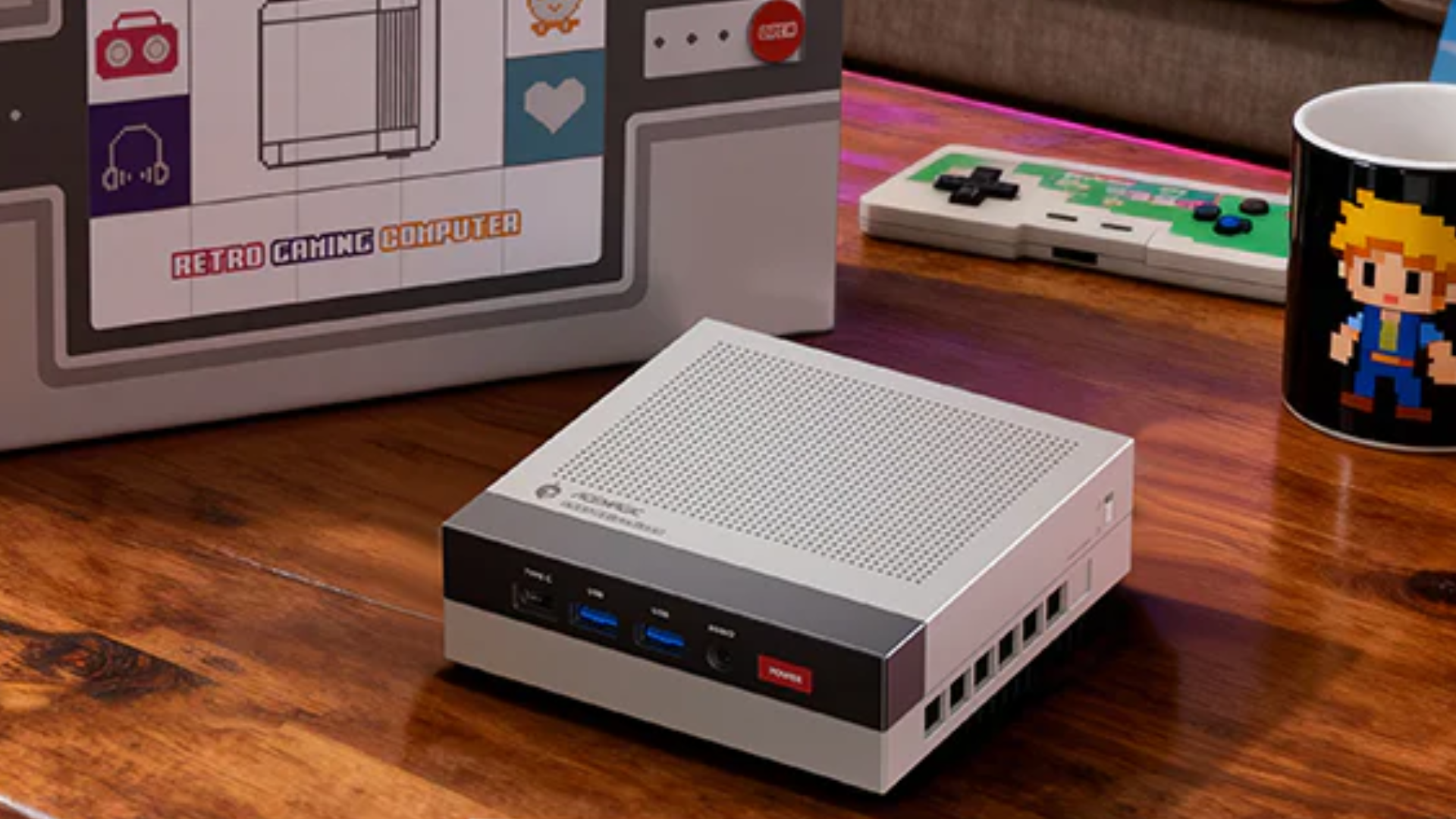The Acemagic X3 mini PC on a coffee table next to a pixel art mug and a box that says 'Retro Gaming Computer'