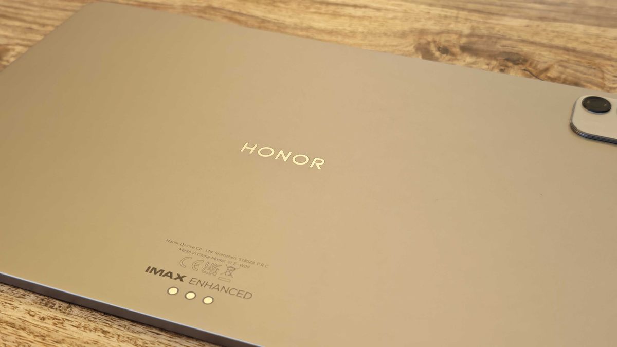 A photograph of the Honor MagicPad 4 in use on a wooden table.