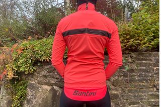 The back of the bright pink Santini Guard Neo rain jacket with tail flap