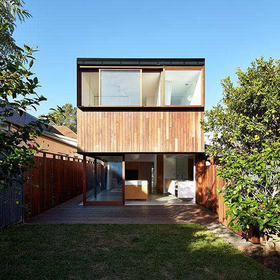 Designed building with large glass panel and grass lawn