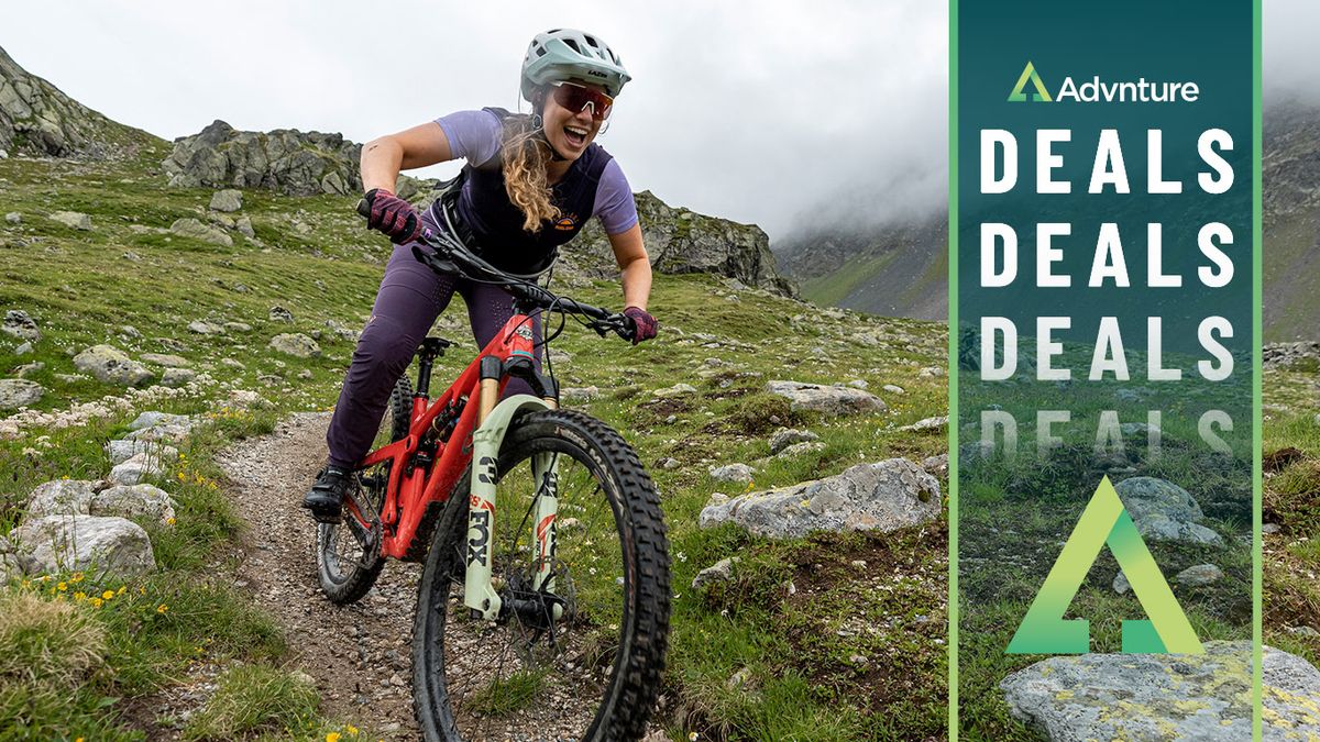 Woman mountain biking downhill