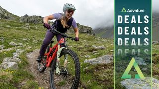 Woman mountain biking downhill