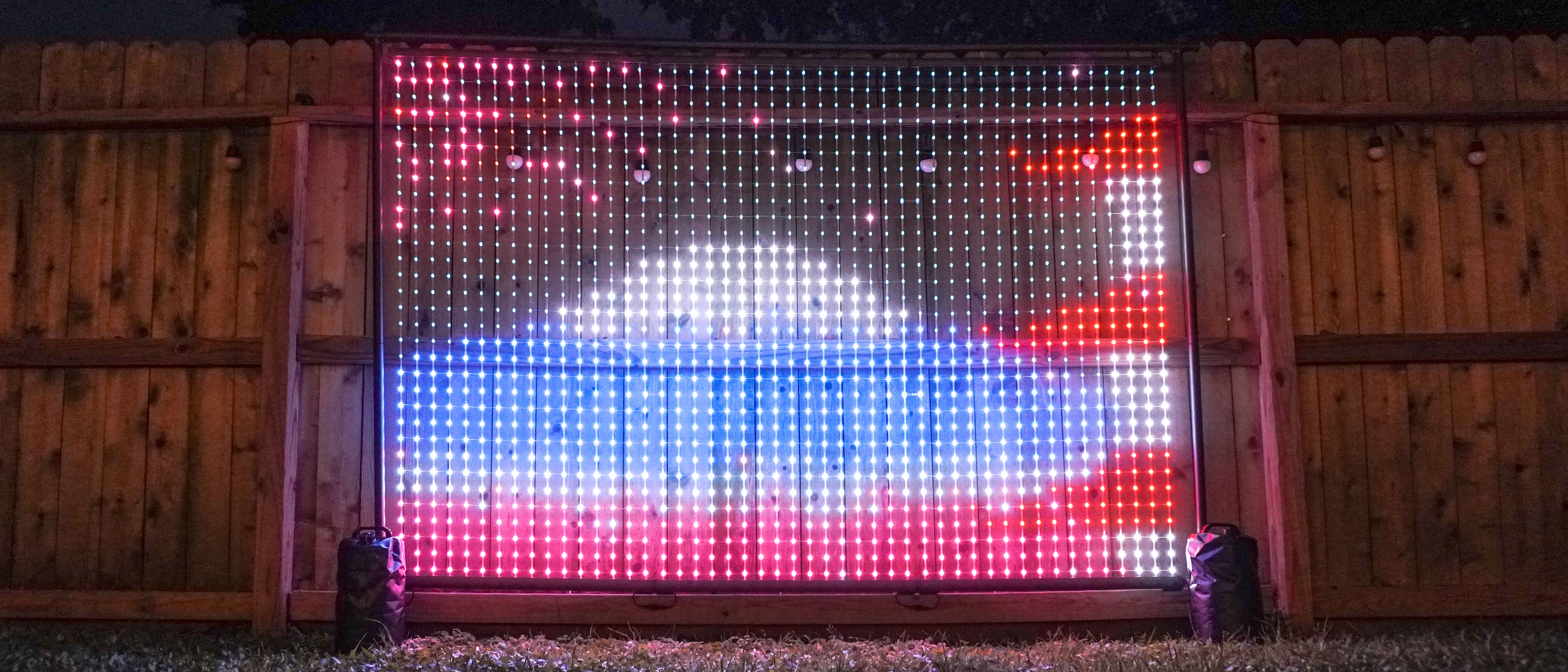 The Govee Lightwall set up in a backyard next to a fence showing a GIF of Mount Fuji