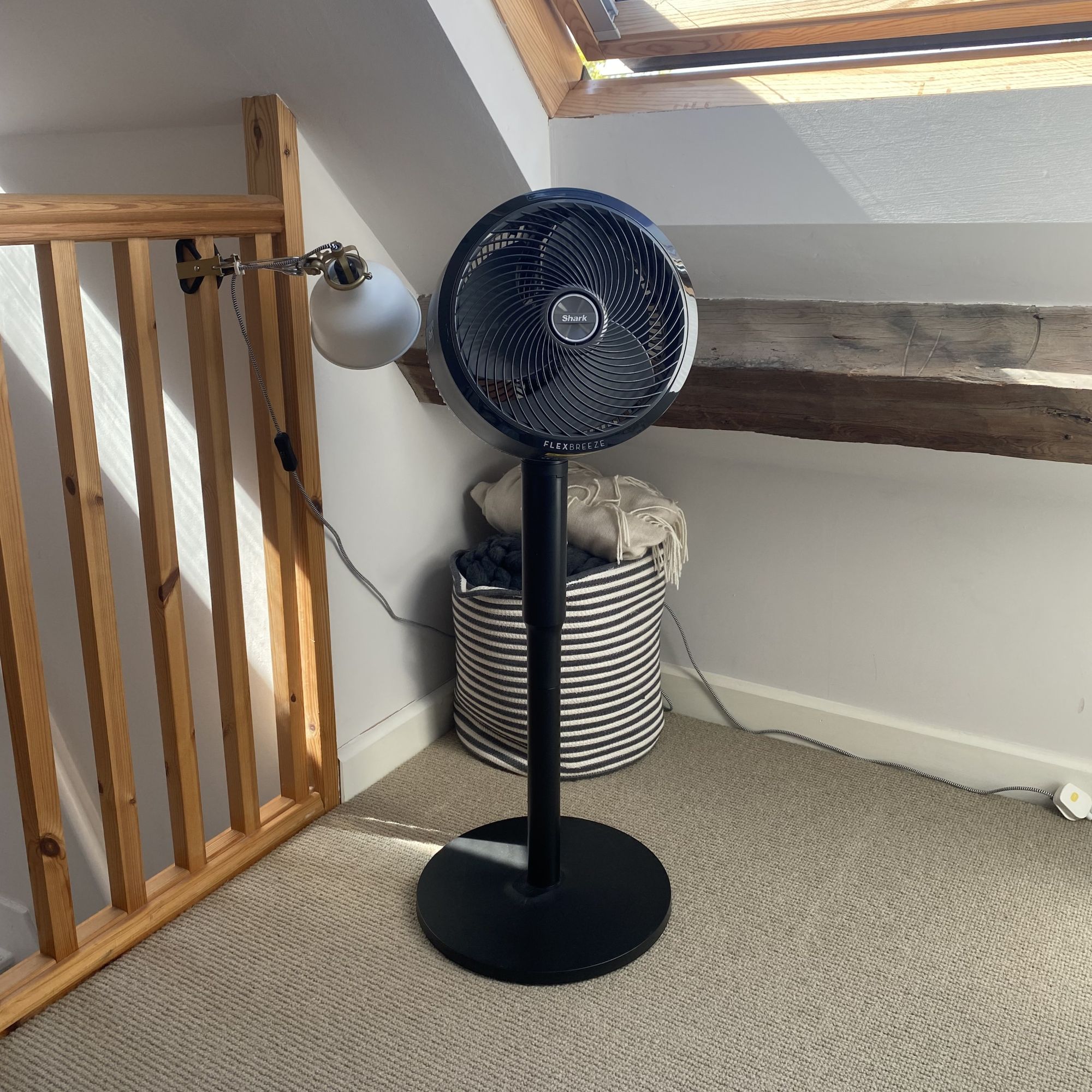 Shark Flexbreeze Portable Fan FA220UK in pedastal form in a loft bedroom with beams and stair railing