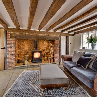 living room with wooden beams and fire place