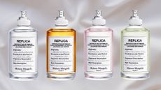 A selection of Maison Margiela REPLICA perfumes, including Lazy Sunday Morning, By The Fireplace, Springtime in A Park and Under The Lemon Trees/ in a white fabric, bedding-like template