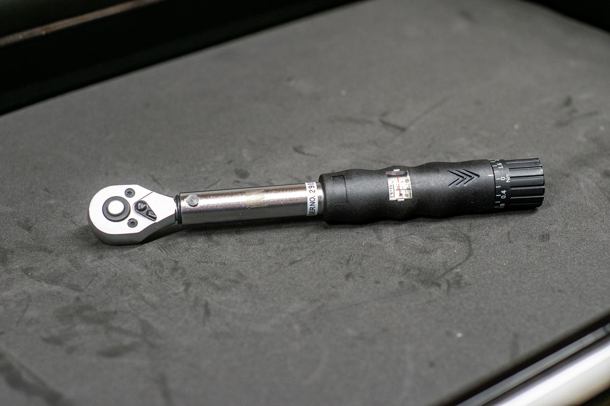 M Part torque wrench on a black workbench