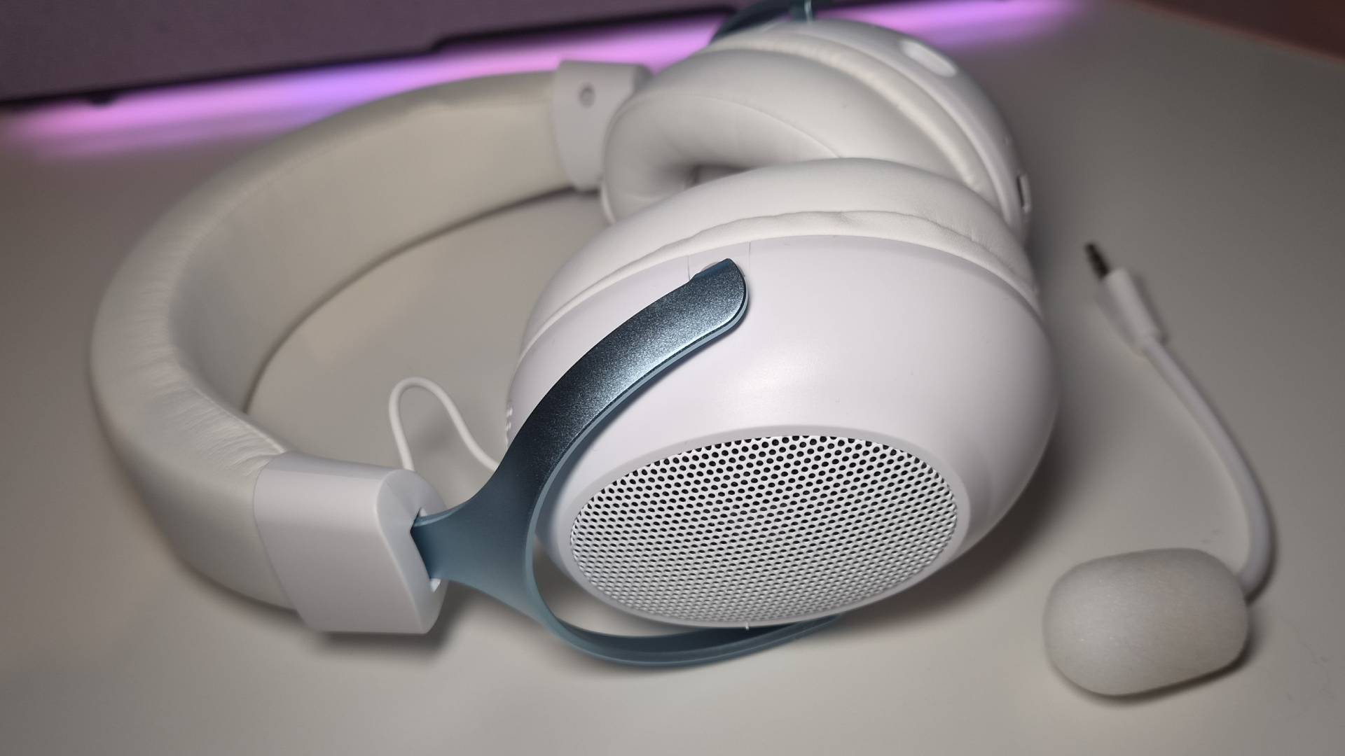 Photo of the Epomaker GX1 headset sitting on a white desk.