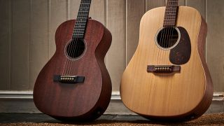 Two Martin guitars leaning against a wall