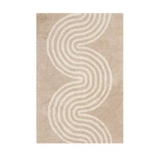 A light brown entryway rug with a white wavy pattern