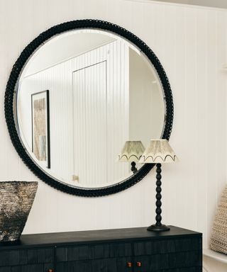 Bobbin furniture: Black painted bobbin mirror and lampshade on a dark cabinet