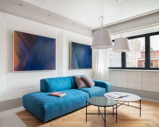 Blue sofa and circular tables in the living room