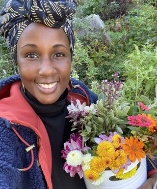 Dee picking cut flowers from her plot