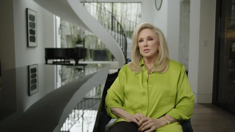 Morgan Fairchild in a fancy room wearing a lime green silky blouse for Matthew Perry: A Hollywood Tragedy