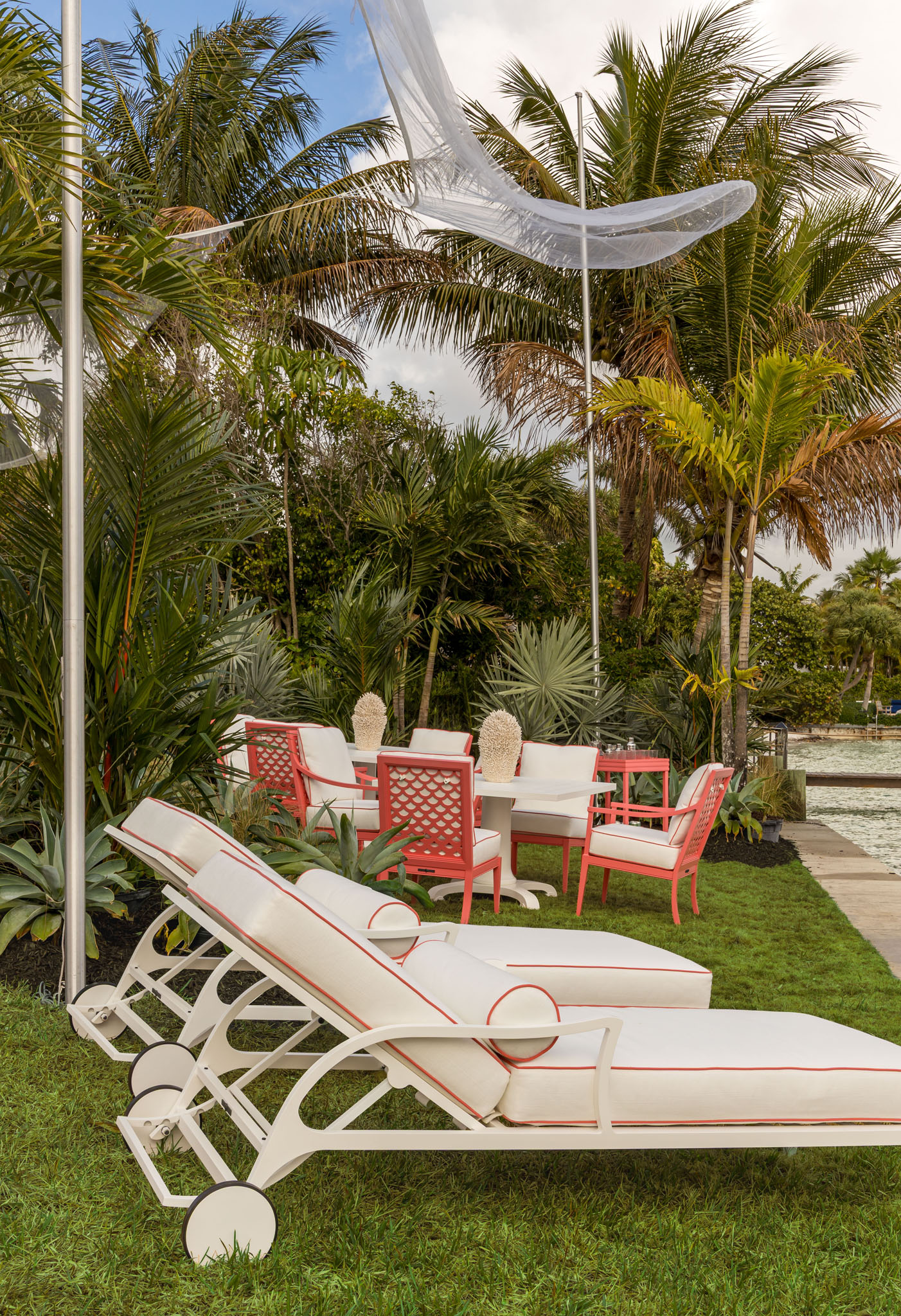 Florida outdoor lawn area featuring pink-piped outdoor chaise lounges