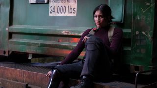 Maya Lopez sits with her back against a forklift truck in Marvel Studios' Echo on Disney Plus