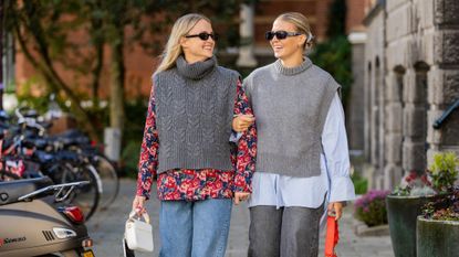 two women wearing gray sweater vests