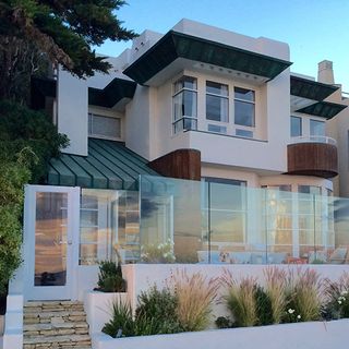 white villa with glass fence