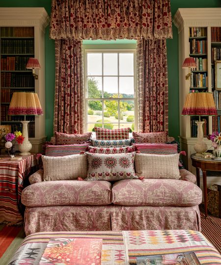 Cozy living room with patterns furnishings and green wall