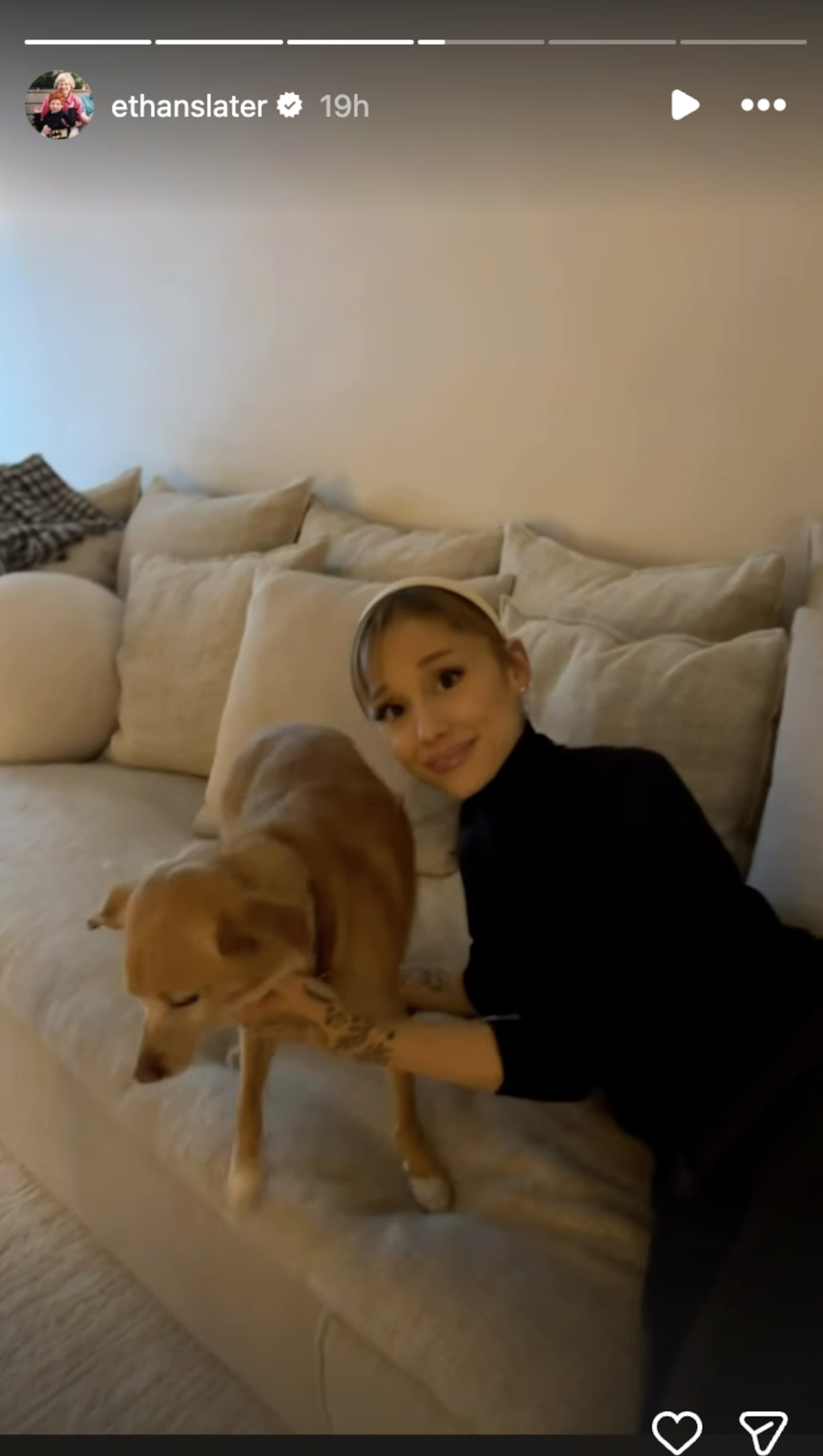 Ethan Slater shares a photo of Ariana Grande relaxing on a couch with a dog over the holidays.