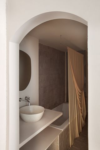 A minimalist bathroom with shower curtain divider