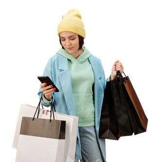 A woman on her phone with a load of shopping bags