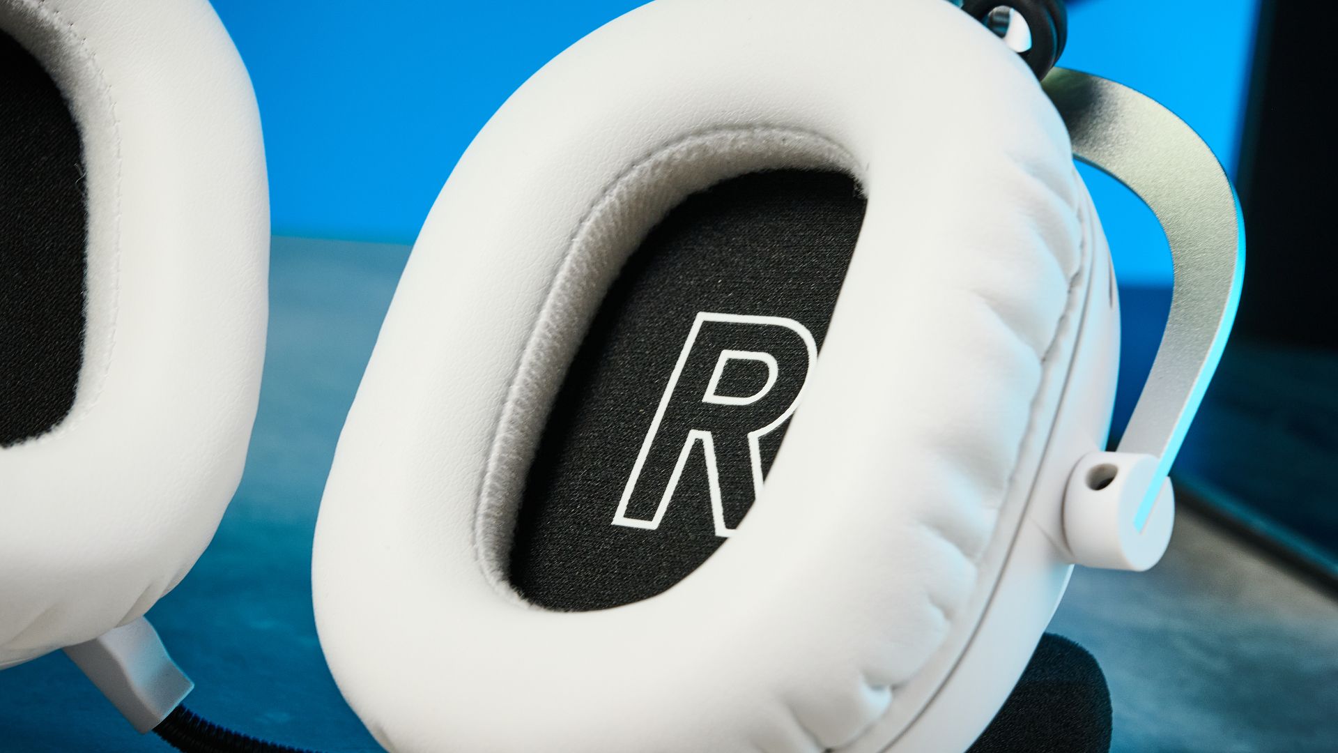 The Logitech G Pro X3 Lightspeed headset in white, on a stone surface.