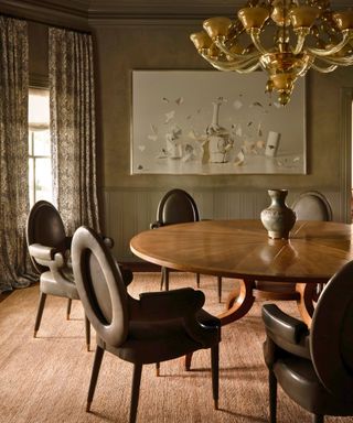 dining room with round wood pedestal table and green-brown leather chairs