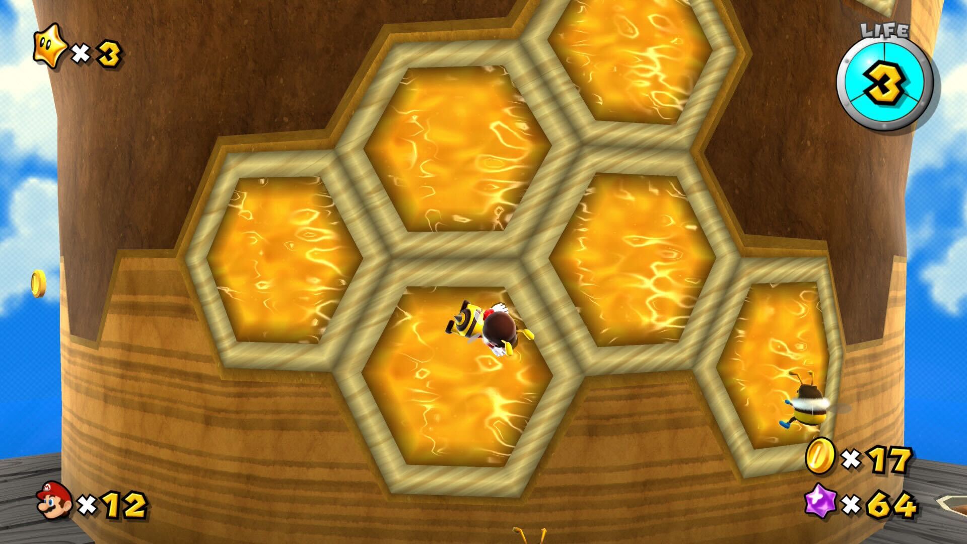 Super Mario Galaxy screenshot of Bee Mario climbing up a honey comb wall