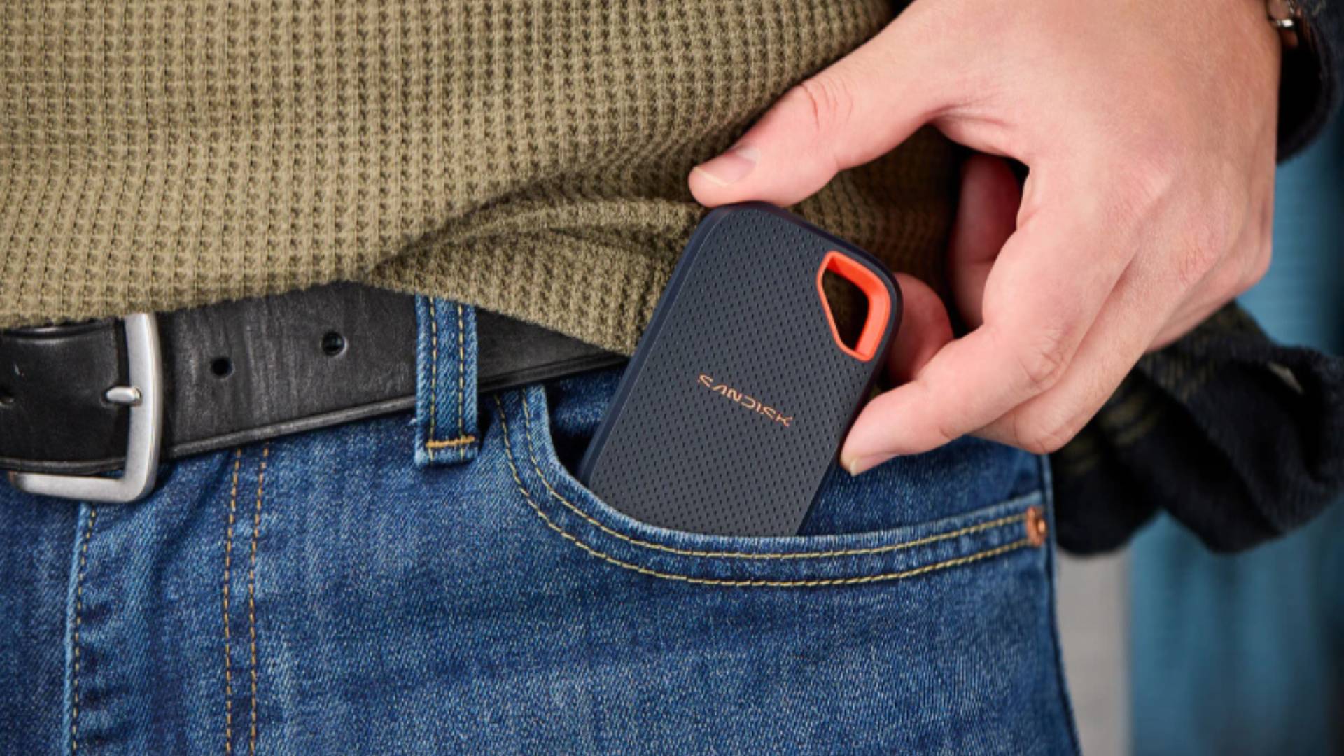 Official marketing image of the SANDISK Extreme Portable SSD in someone's jean pocket.