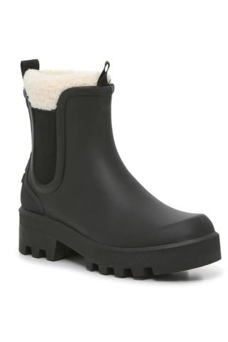 black rain Chelsea boots with white fur trim